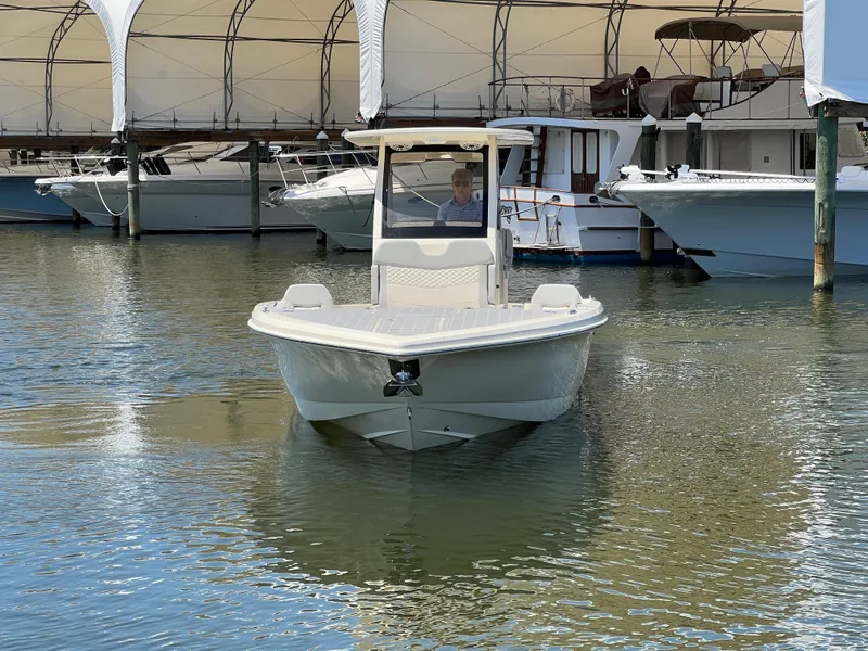 Slide: The Image of 2025 Scout 281 XSS boat docked in a marina, front view. - 3