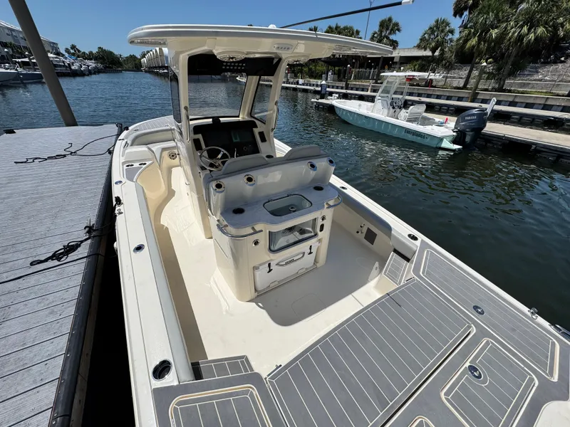 Slide: The Image of 2025 Scout 281 XSS boat docked by a marina, showcasing spacious deck and modern design. - 5