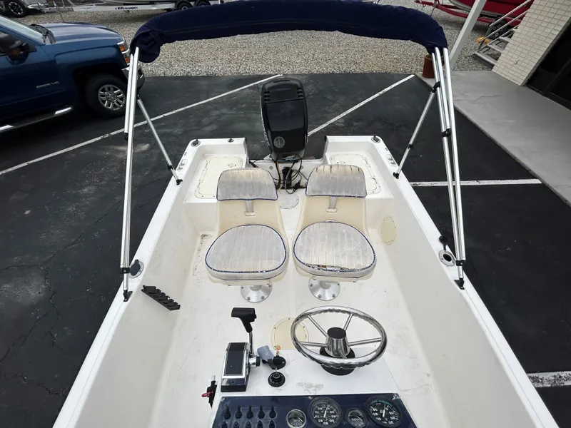 Slide: The Image of 2001 Sea Fox 172 CC 90 HP boat interior with steering wheel and seating. - 12