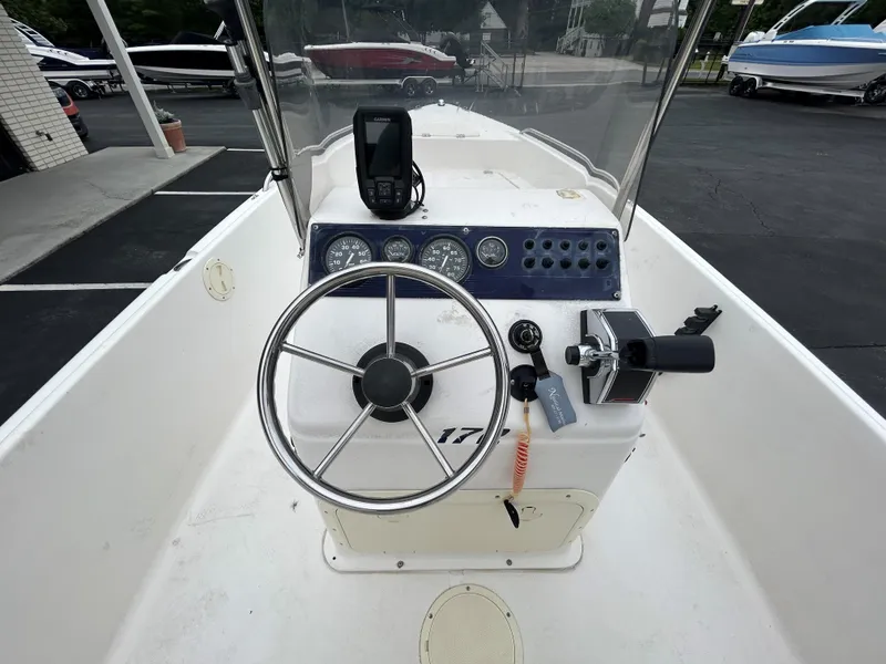 Slide: The Image of 2001 Sea Fox 172 CC boat dashboard with steering wheel and controls. - 14