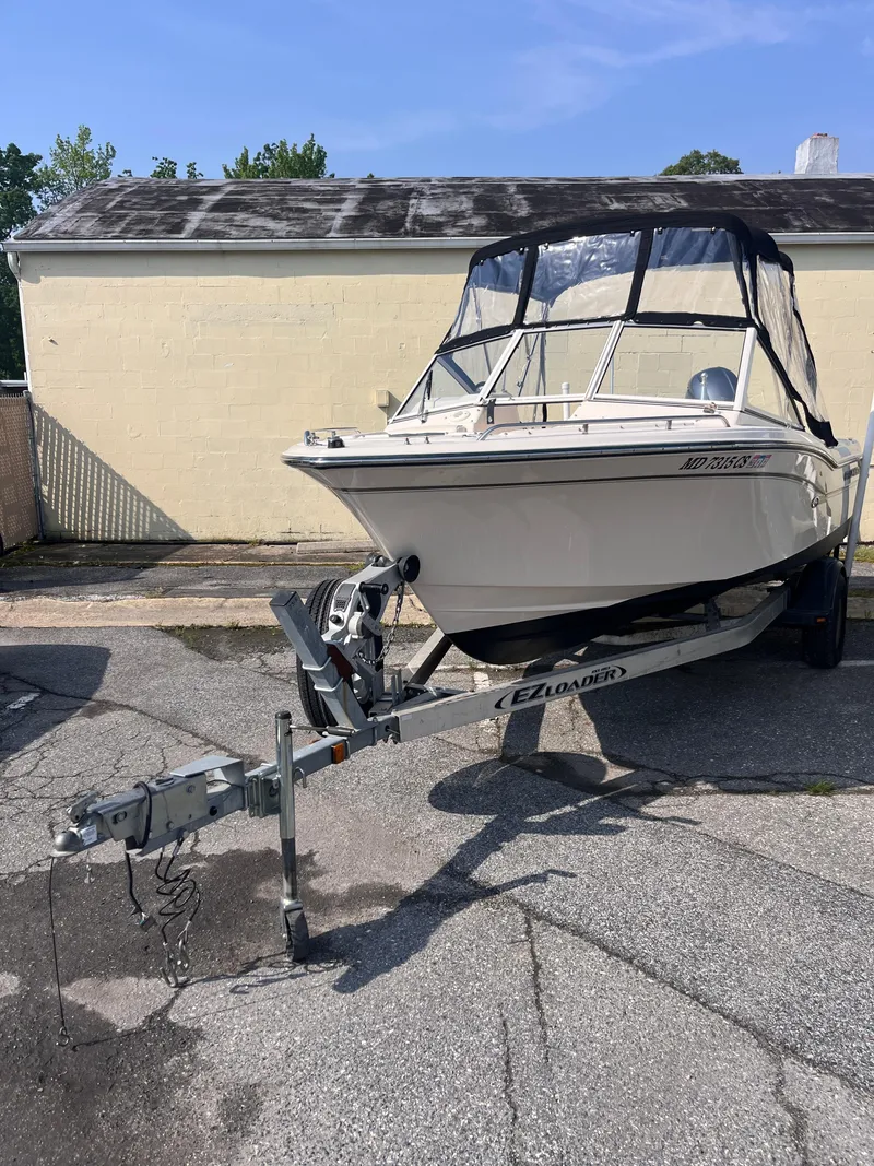 Slide: The Image of 2017 Grady-White Freedom 192 boat on trailer, parked outdoors. - 1