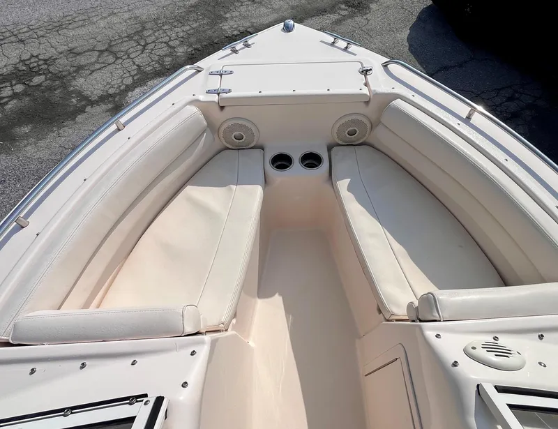 Slide: The Image of 2017 Grady-White Freedom 192 boat interior with cushioned seating and cup holders. - 12