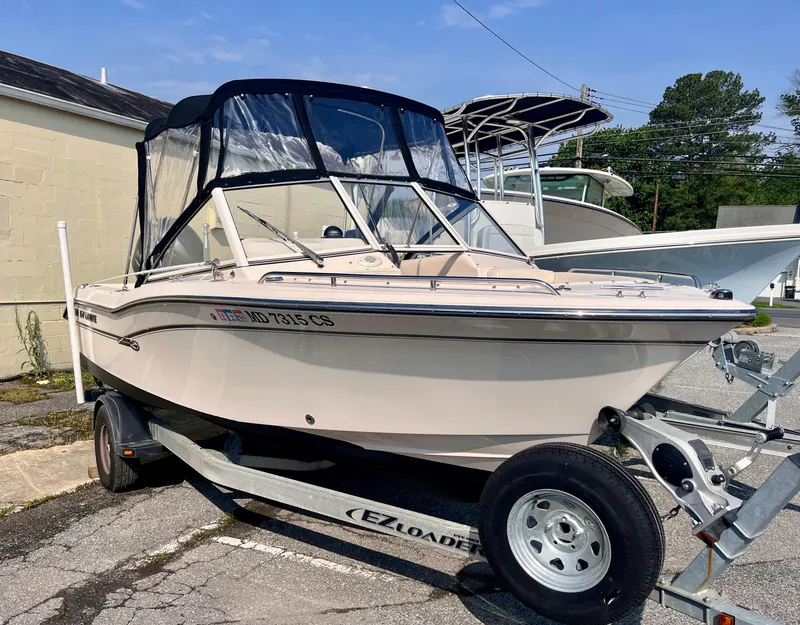 Slide: The Image of 2017 Grady-White Freedom 192 boat on trailer, parked outdoors. - 2