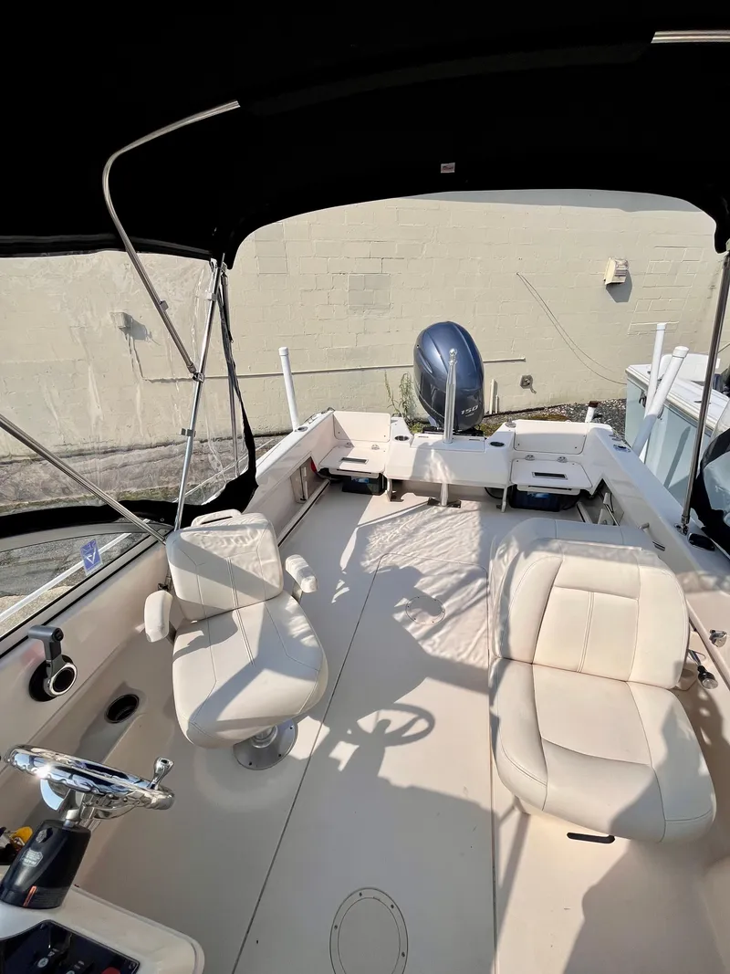 Slide: The Image of 2017 Grady-White Freedom 192 boat interior with seating and steering wheel. - 8