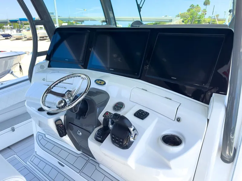 Slide: The Image of 2019 HCB 53 Sueños boat helm with multiple screens and controls. - 17