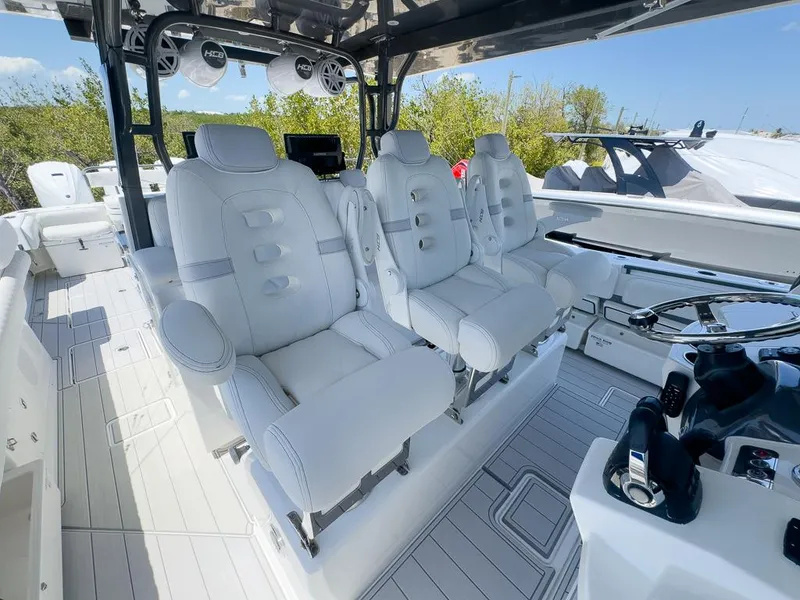 Slide: The Image of 2019 HCB 53 Sueños boat interior with luxurious white seating and modern controls. - 18