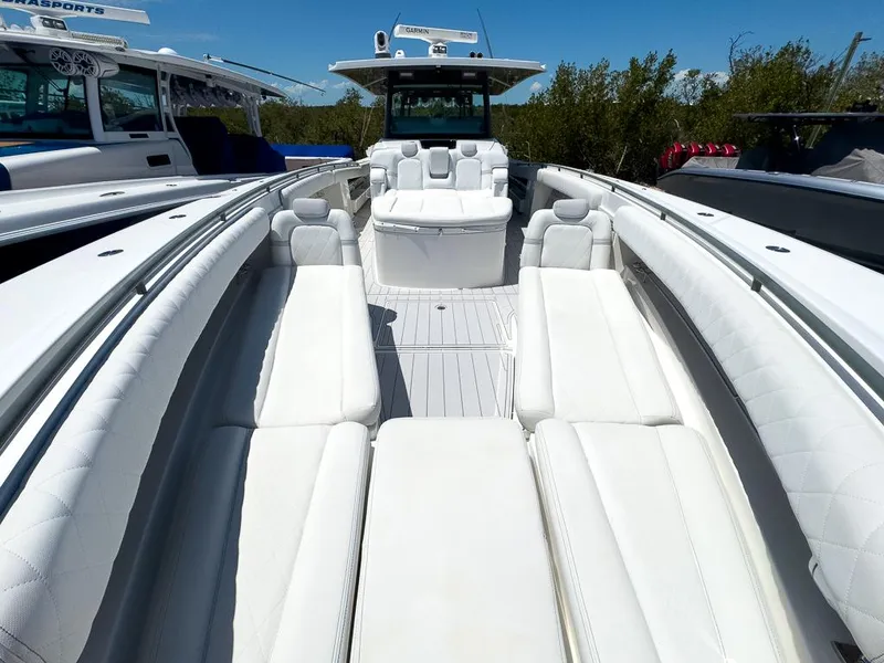 Slide: The Image of 2019 HCB 53 Sueños luxury boat with spacious white seating and sleek design. - 23