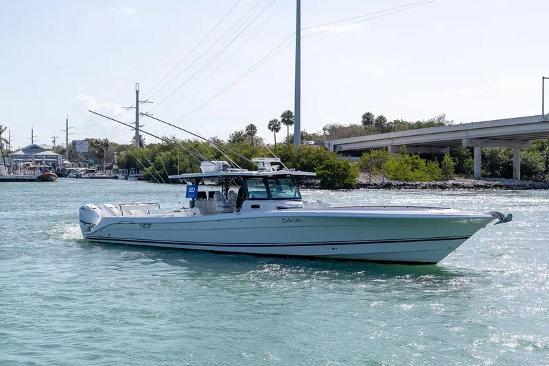 Slide: The Image of 2019 HCB 53 Sueños boat cruising on a sunny day near a bridge. - 4
