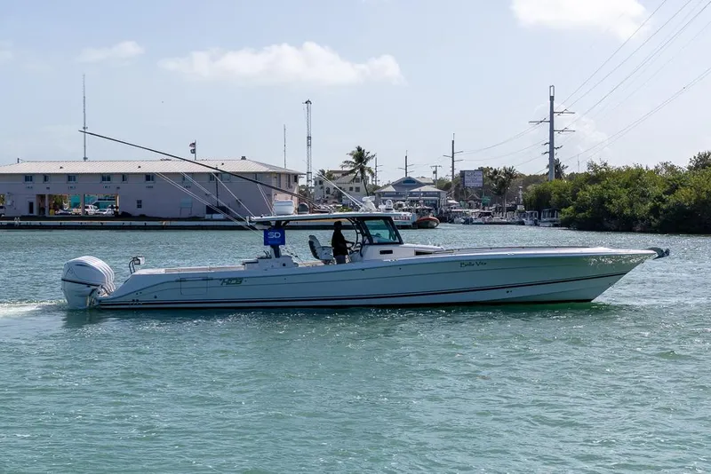 Slide: The Image of 2019 HCB 53 Sueños boat cruising in a marina under a clear sky. - 5