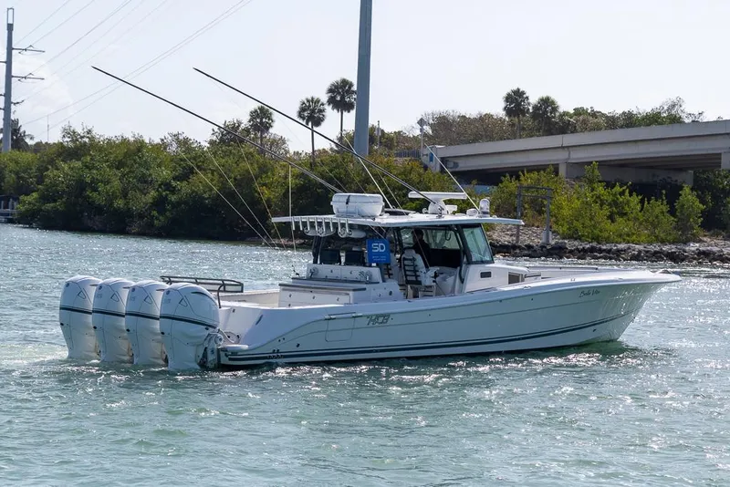 Slide: The Image of 2019 HCB 53 Sueños boat with four engines cruising on a sunny waterway. - 6