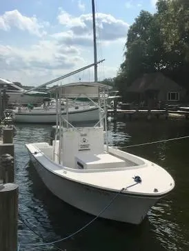 Slide: The Image of Custom 1999 pump out boat docked at marina under cloudy sky. - 1