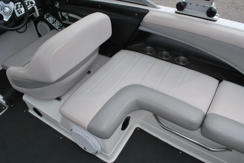 Slide: The Image of 2007 MasterCraft X45 boat interior with gray seating and cup holders. - 10