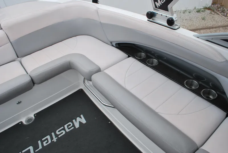Slide: The Image of 2007 MasterCraft X45 boat interior with gray seating and cup holders. - 11