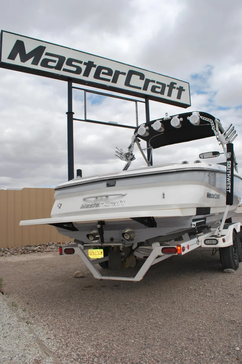 Slide: The Image of 2007 MasterCraft X45 boat on trailer under MasterCraft sign. - 16