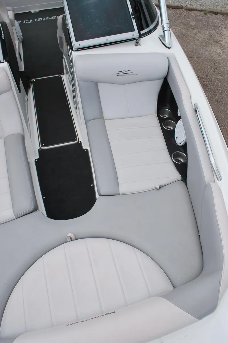 Slide: The Image of 2007 MasterCraft X45 boat interior with white seating and cup holders. - 4