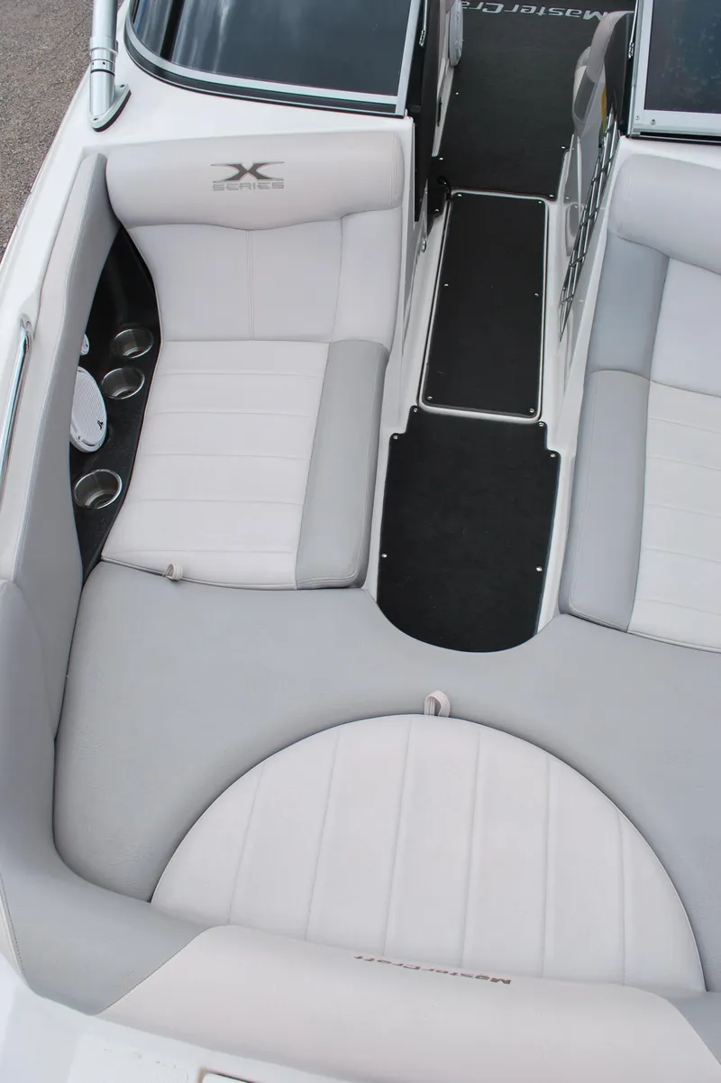 Slide: The Image of 2007 MasterCraft X45 boat interior with gray seating and cup holders. - 5