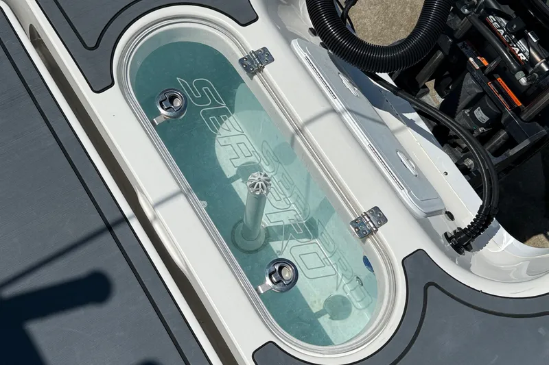 Slide: The Image of 2021 Sea Pro 248 Bay livewell with clear lid and water inside. - 10