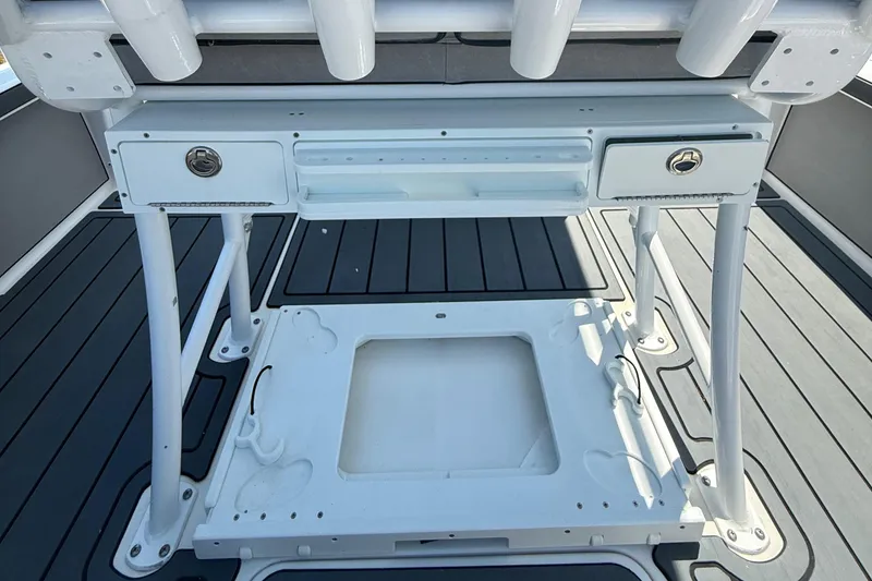 Slide: The Image of 2021 Sea Pro 248 Bay boat deck with storage compartments and rod holders. - 12