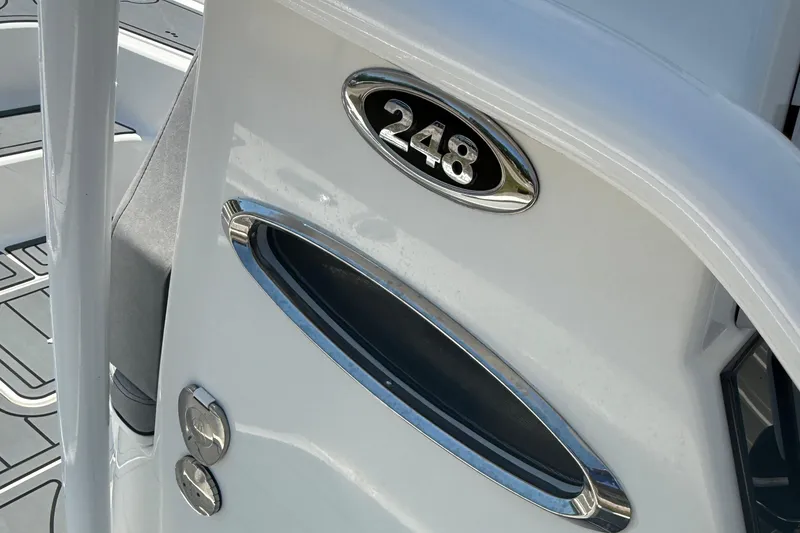 Slide: The Image of 2021 Sea Pro 248 Bay boat detail with chrome accents and model emblem. - 14