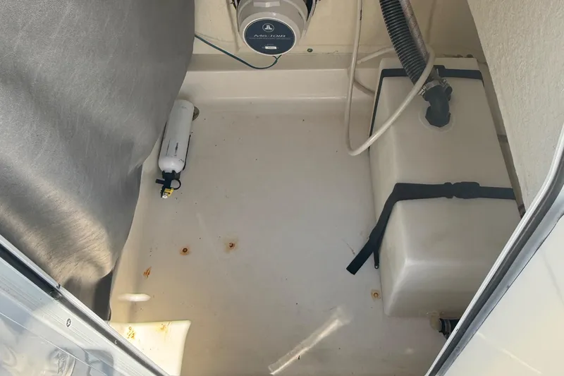 Slide: The Image of 2021 Sea Pro 248 Bay interior storage compartment with equipment and wiring. - 21