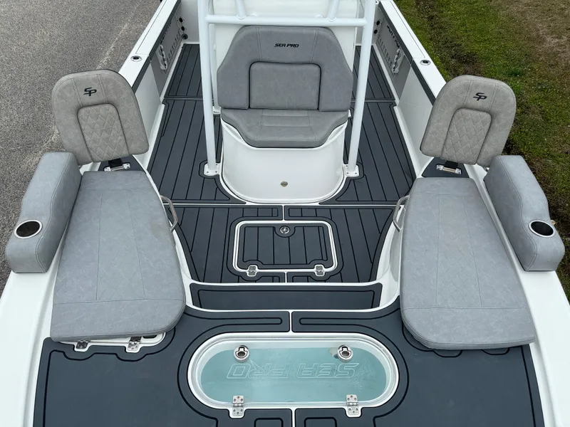 Slide: The Image of 2021 Sea Pro 248 Bay boat interior with gray seating and deck layout. - 5