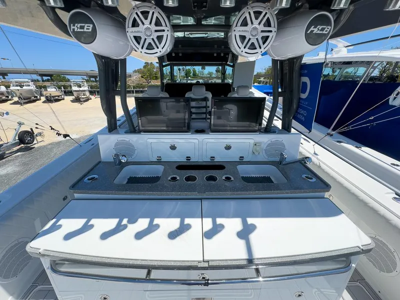 Slide: The Image of 2019 HCB 53 Sueños boat interior with speakers and fishing rod holders. - 13
