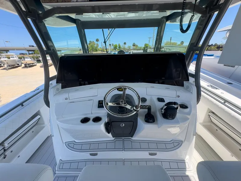 Slide: The Image of 2019 HCB 53 Sueños boat helm with steering wheel and controls. - 14