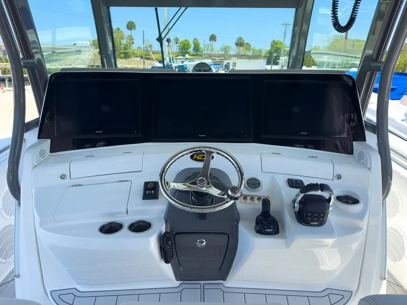 Slide: The Image of Helm of 2019 HCB 53 Sueños boat with modern controls and navigation screens. - 15