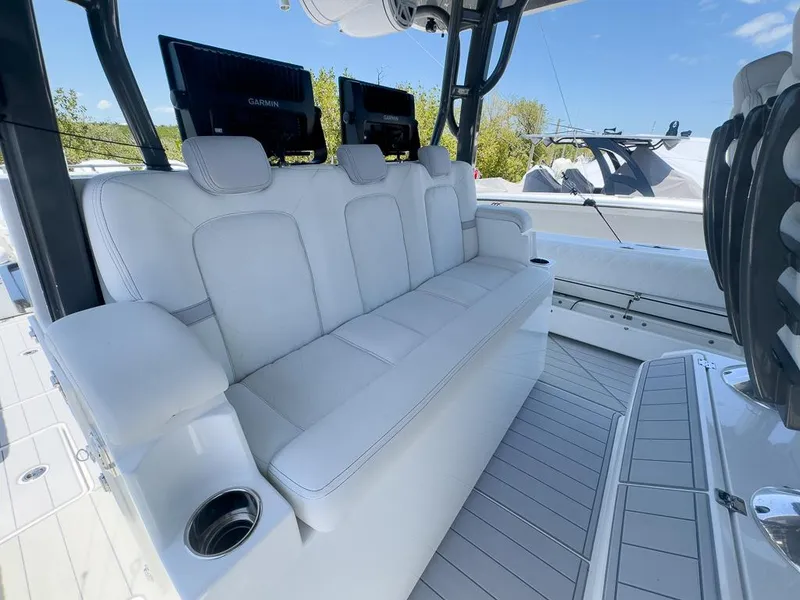Slide: The Image of 2019 HCB 53 Sueños boat with luxurious white seating and modern navigation screens. - 19