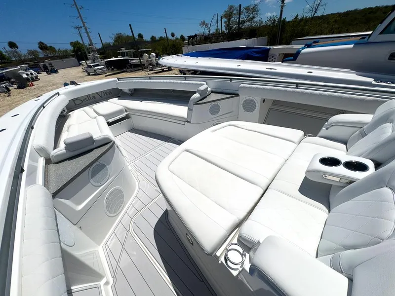 Slide: The Image of 2019 HCB 53 Sueños boat interior with white seating and cup holders. - 20