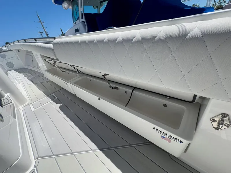 Slide: The Image of 2019 HCB 53 Sueños boat with white seating and storage compartments. - 28
