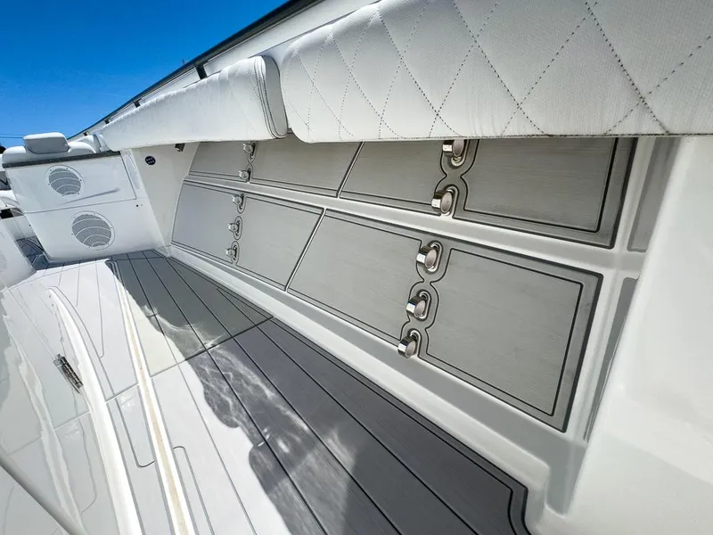 Slide: The Image of 2019 HCB 53 Sueños boat interior with sleek storage compartments and cushioned seating. - 29