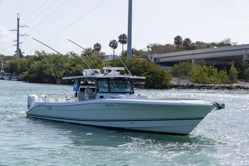 Slide: The Image of 2019 HCB 53 Sueños boat cruising on a calm waterway near lush greenery. - 3