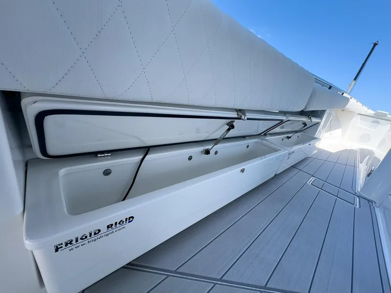 Slide: The Image of HCB 53 Sueños 2019 boat with open storage compartment and Frigid Rigid cooler. - 31