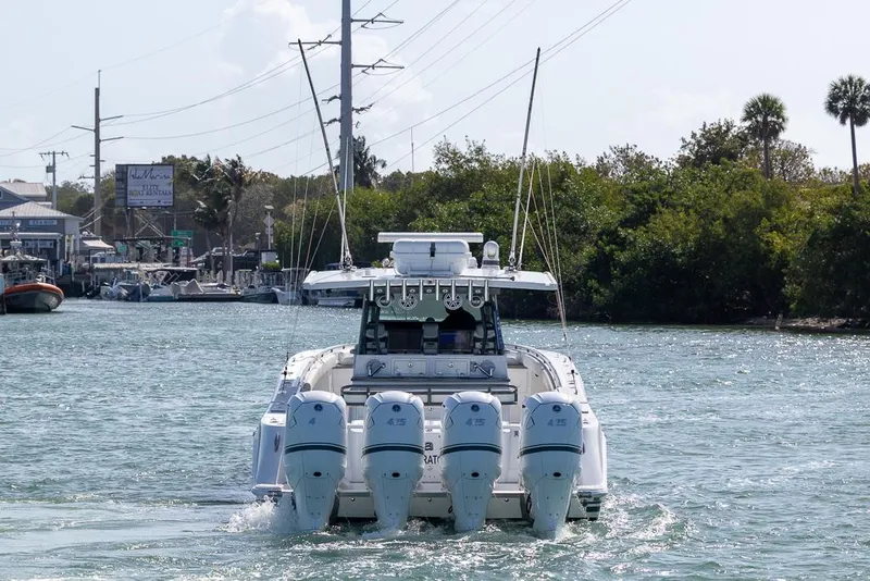 Slide: The Image of 2019 HCB 53 Sueños boat with four engines cruising on a waterway. - 7