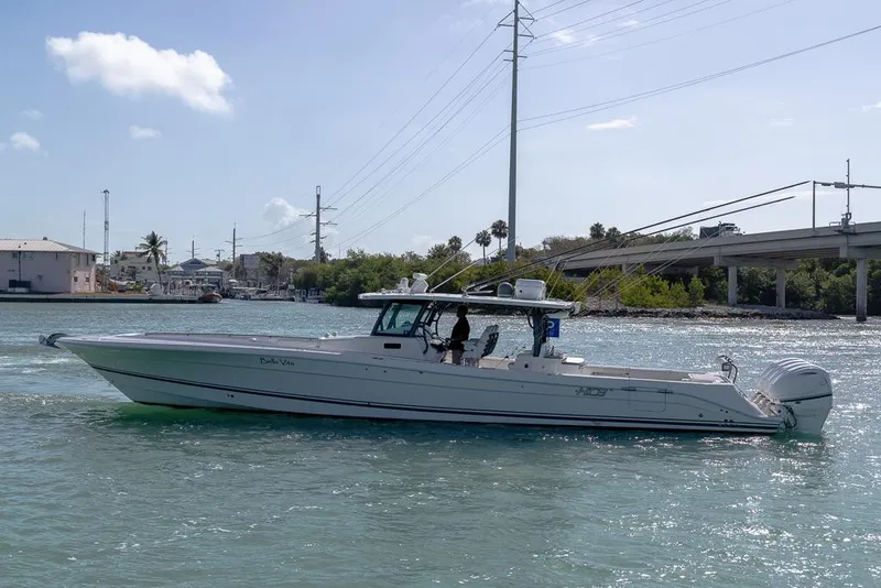 Slide: The Image of 2019 HCB 53 Sueños boat cruising on a sunny day near a bridge. - 9