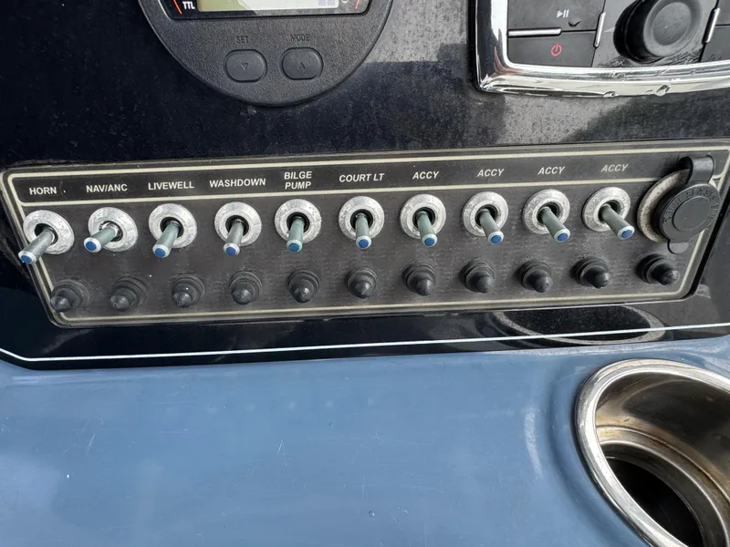 Slide: The Image of Control panel of a 2016 Tidewater 230 LXF boat with labeled switches. - 11