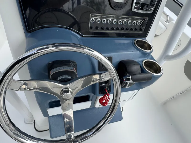 Slide: The Image of Steering console of 2016 Tidewater 230 LXF boat with controls and cup holders. - 12