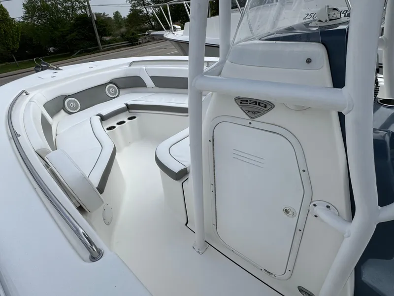 Slide: The Image of 2016 Tidewater 230 LXF boat interior with cushioned seating and storage. - 14