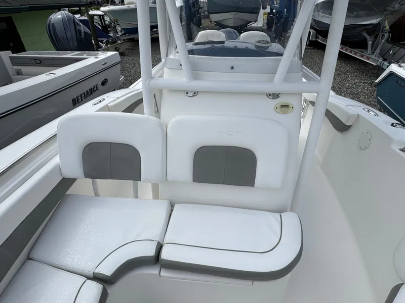 Slide: The Image of 2016 Tidewater 230 LXF boat interior with white cushioned seating. - 17