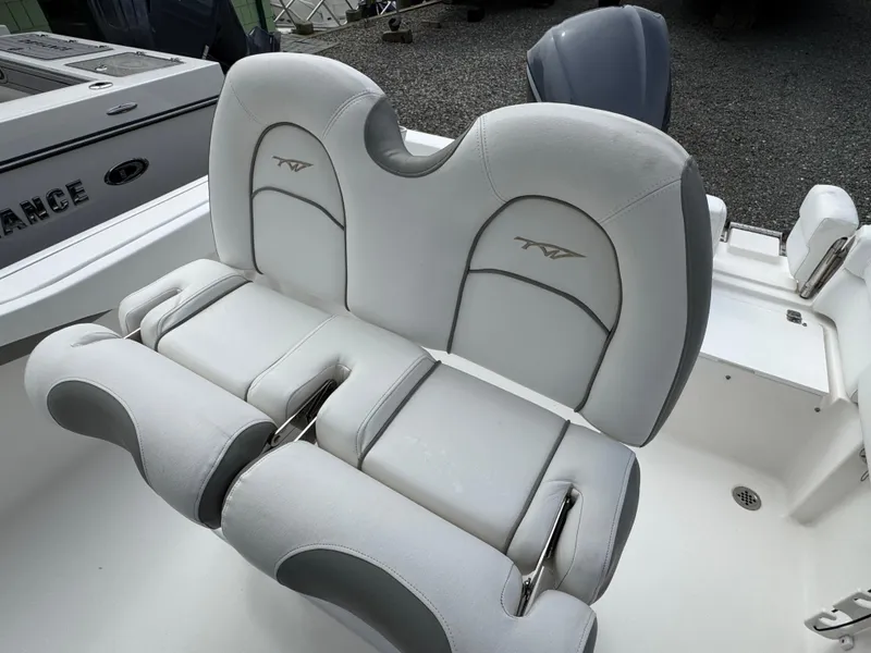 Slide: The Image of 2016 Tidewater 230 LXF boat seating with gray and white upholstery. - 6
