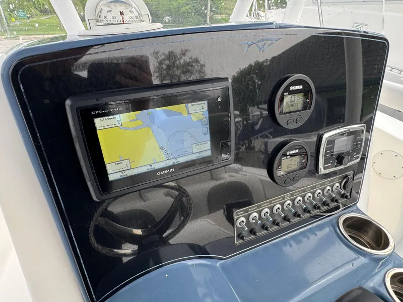 Slide: The Image of 2016 Tidewater 230 LXF boat dashboard with Garmin navigation system and Yamaha controls. - 8