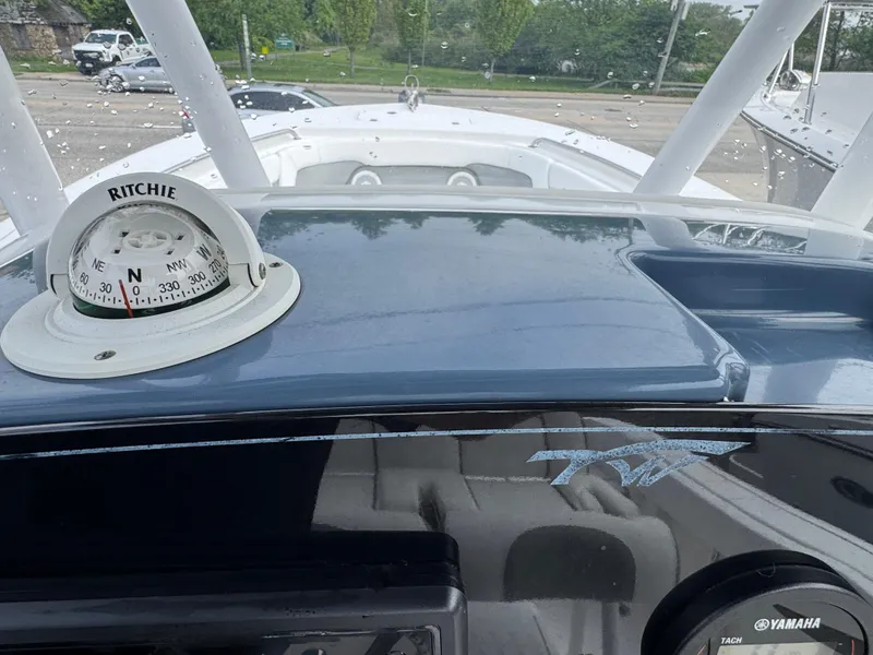 Slide: The Image of 2016 Tidewater 230 LXF boat dashboard with Ritchie compass and Yamaha controls. - 9