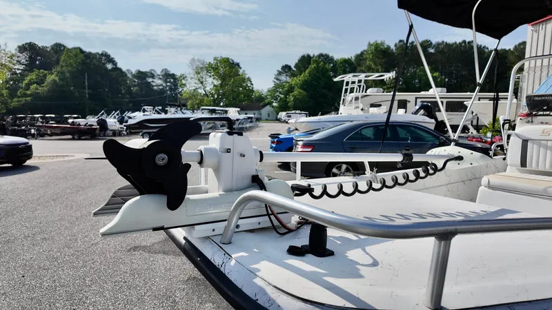 Slide: The Image of 2008 Carolina Skiff 16 DLX boat with trolling motor in a marina setting. - 11