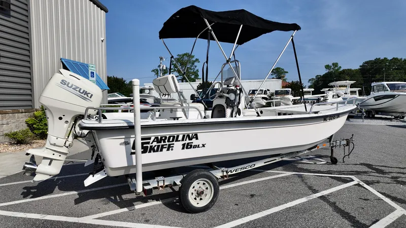 Slide: The Image of 2008 Carolina Skiff 16 DLX boat with Suzuki outboard motor on a trailer. - 14