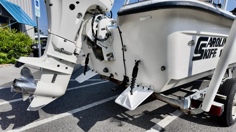 Slide: The Image of 2008 Carolina Skiff 16 DLX boat on trailer, showing motor and hull details. - 15