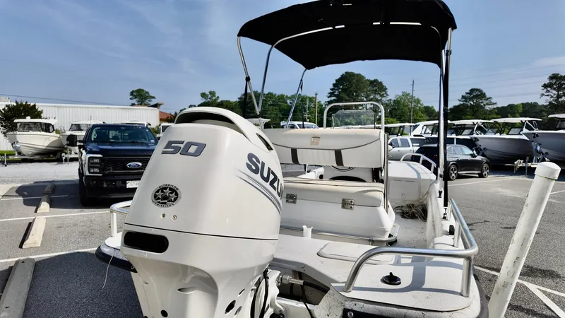Slide: The Image of 2008 Carolina Skiff 16 DLX boat with Suzuki 50 engine in a parking lot. - 4