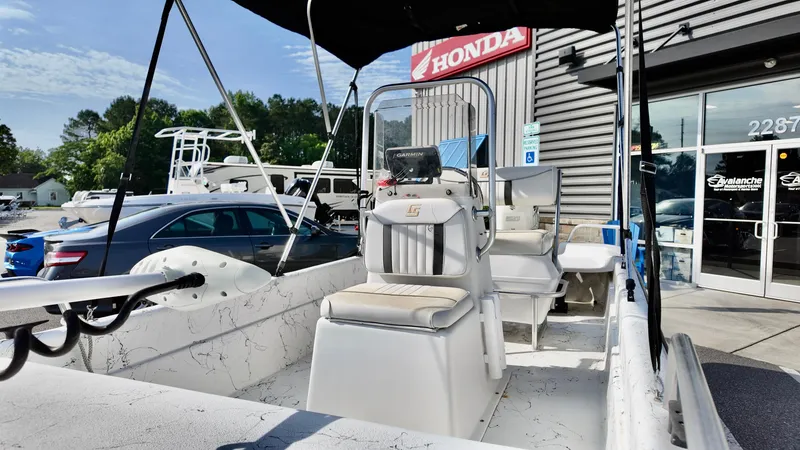 Slide: The Image of 2008 Carolina Skiff 16 DLX boat displayed outside a Honda dealership. - 6