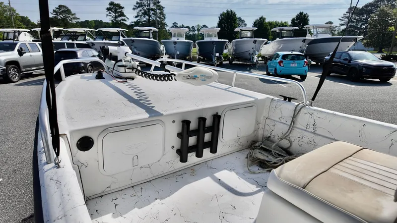 Slide: The Image of 2008 Carolina Skiff 16 DLX boat interior with seating and storage, parked in a lot. - 7