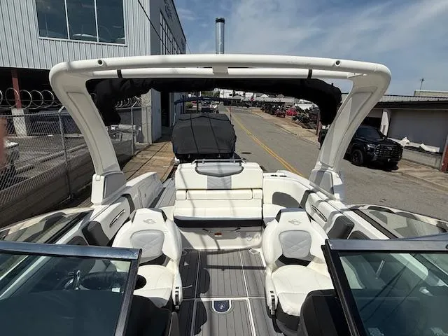 Slide: The Image of 2023 Chaparral 267 SSX boat interior with white seating and open deck design. - 12